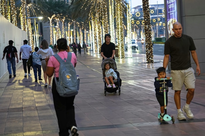 People walk along a main street in downtown Dubai.